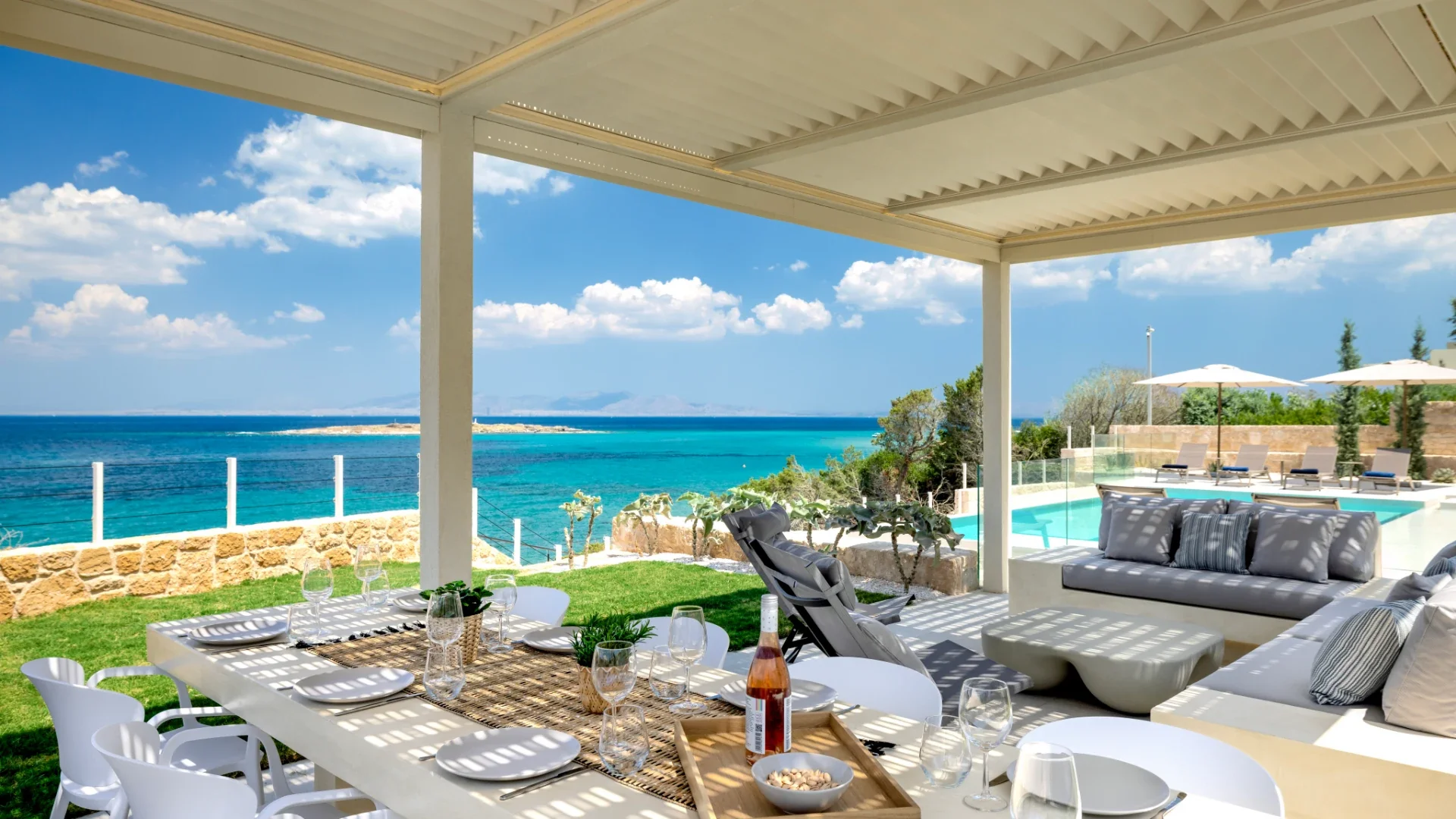 Covered outdoor dining terrace with sea view