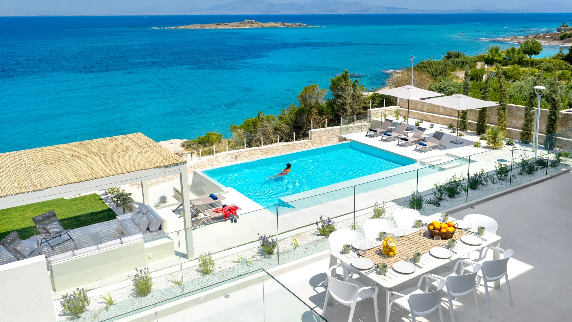 Garden seating area overlooking the pool and sea